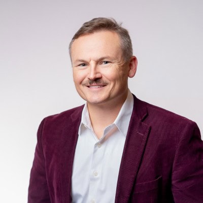 Portrait of Michael Malone, Identity and Access Governance Senior Consultant at Omada, smiling in a professional colored headshot