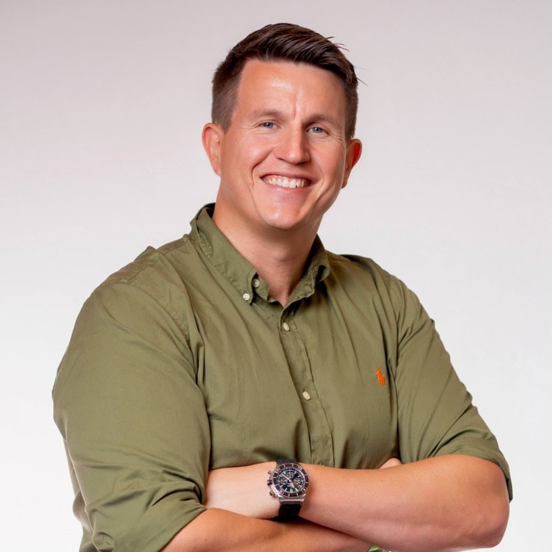 Portrait of Craig Ramsay, Senior Solution Architect at Omada, smiling with arms crossed in a professional headshot against a light background
